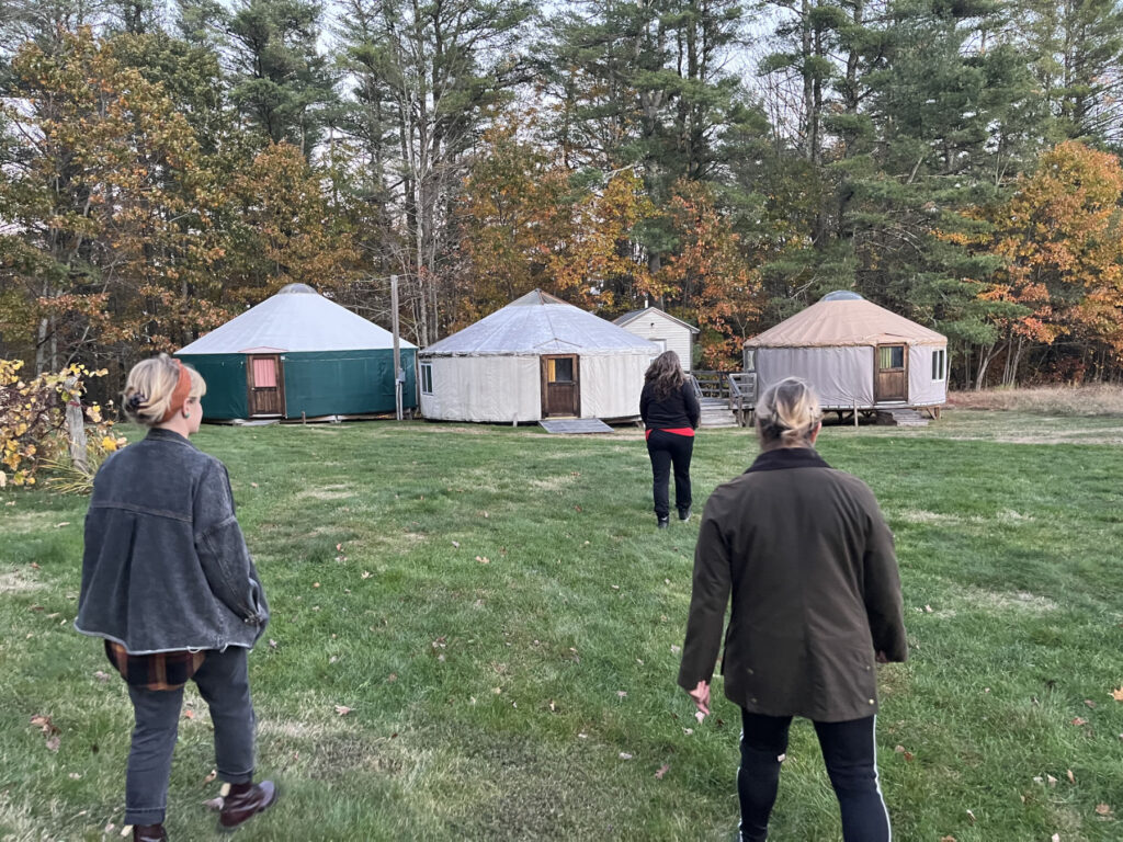 group walking to yurts